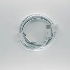 Biały, pleciony kabel **usb typu c** z logo marki, zwinięty w okrąg i zabezpieczony papierowymi opaskami.