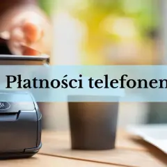 Zbliżenie na terminal płatniczy i kubek kawy. Dłoń trzyma smartfon, gotowa do płatności telefonem.