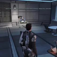 W grze Mass Effect, opiekunowie pomagają w nawigacji. Postać gracza stoi przed mechanicznym stworzeniem w futurystycznym wnętrzu.