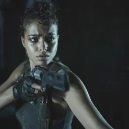 Kobieta z pistoletem, zdeterminowana, w mrocznym otoczeniu. Czy to Jill Valentine z Resident Evil Remedium?