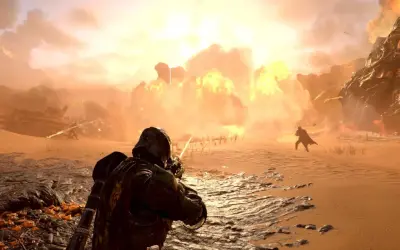 Helldivers 2: żołnierz strzela na pustynnym polu bitwy, podczas gdy w tle wybucha potężna eksplozja.