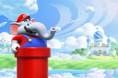 Słoń Mario z serii Super Mario wychyla się z czerwonej rury na tle bajkowej krainy z zamkiem.