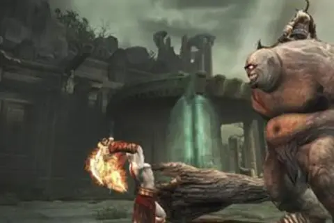 Kratos z płonącym ostrzem walczy z olbrzymim potworem w mrocznym świecie God of War 2.