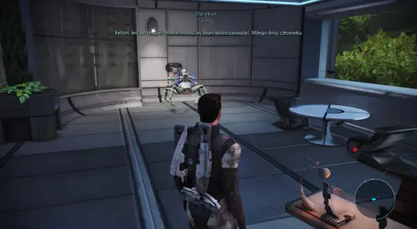 W grze Mass Effect, opiekunowie pomagają w nawigacji. Postać gracza stoi przed mechanicznym stworzeniem w futurystycznym wnętrzu.