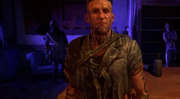 Damien z Dying Light 2, z tatuażami na twarzy i szyi, stoi w ponurym pomieszczeniu.
