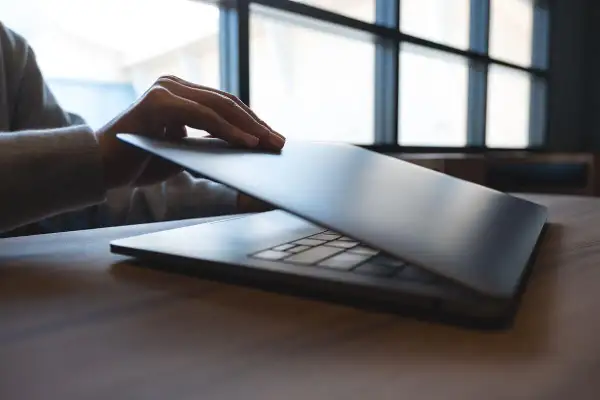 Dłoń zamyka smukły ultrabook. Co to jest? Lekki, wydajny laptop do pracy i rozrywki.