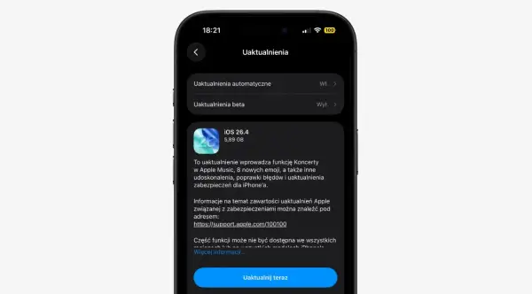 Ekran iPhone'a z informacją o aktualizacji iOS 26.4, która dodaje funkcję Koncerty w Apple Music i nowe emoji.